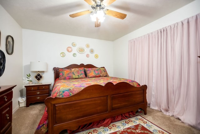 bedroom with light colored carpet, ceiling fan, and baseboards