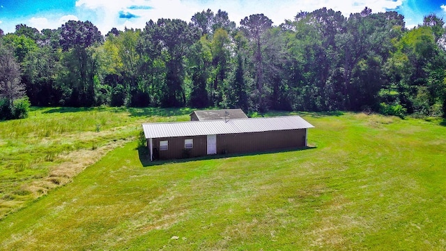 exterior space featuring an outbuilding, a yard, and a pole building
