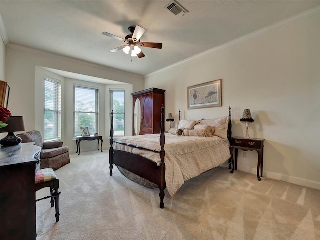 bedroom with ceiling fan, light colored carpet, and crown molding