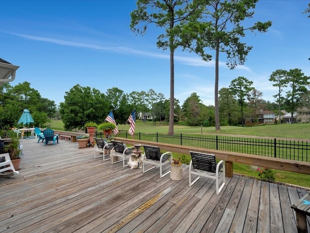 wooden terrace with a lawn