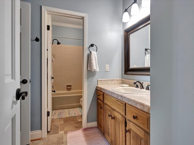 full bathroom with vanity, toilet, crown molding, and tiled shower / bath combo