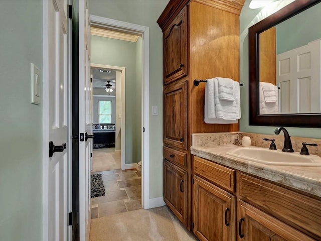 bathroom featuring ceiling fan and vanity