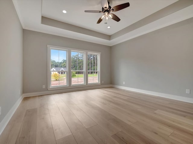 234 Lancewood Dr, Lufkin, TX 75904 - empty room featuring a tray ceiling, light wood-style flooring, ceiling fan, and recessed lighting