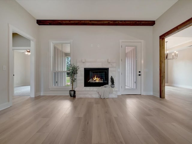 234 Lancewood Dr, Lufkin, TX 75904 - unfurnished living room with a tile fireplace, a chandelier, beamed ceiling, light wood-style floors, and ceiling fan