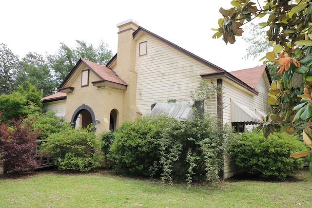 view of property exterior with a yard