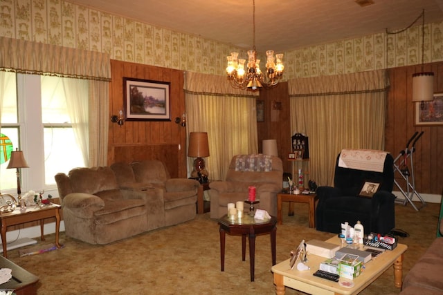 living room featuring carpet flooring, wood walls, and an inviting chandelier