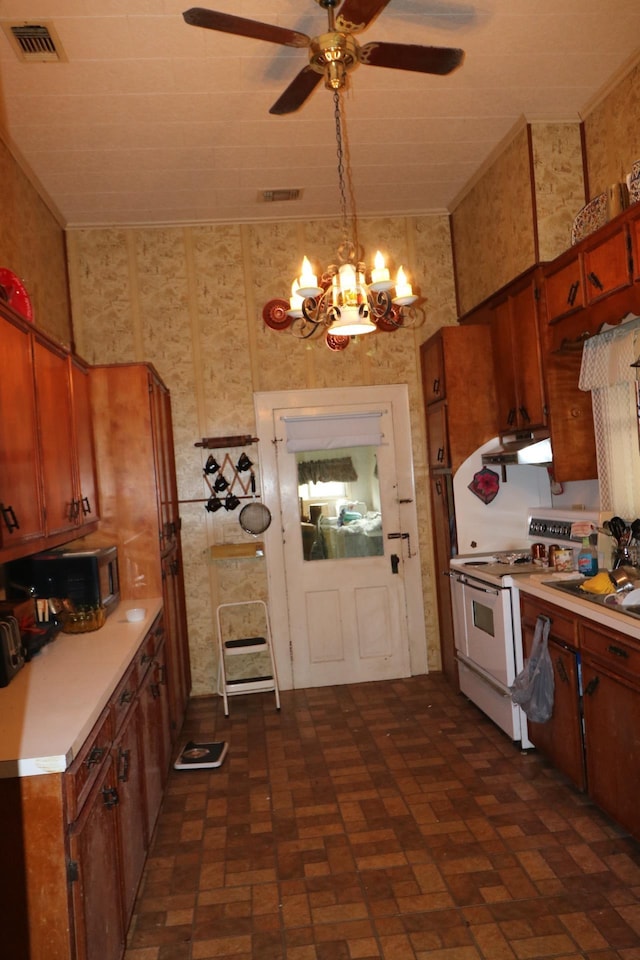 kitchen featuring ceiling fan with notable chandelier and electric stove