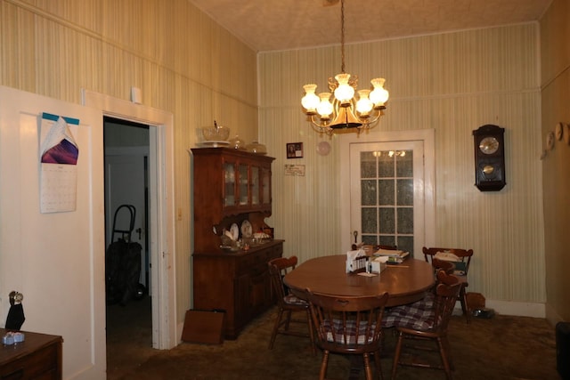 carpeted dining room featuring a notable chandelier