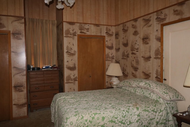 bedroom with carpet and wooden walls