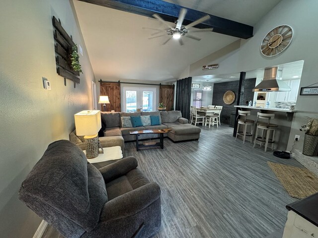 270 Lakeshore Dr, Brookeland, TX 75931 - living area with beamed ceiling, a ceiling fan, wood finished floors, high vaulted ceiling, and a barn door