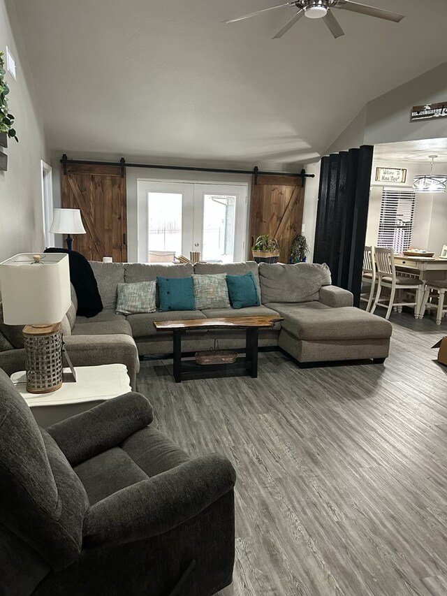 270 Lakeshore Dr, Brookeland, TX 75931 - living area with a barn door, ceiling fan, vaulted ceiling, and wood finished floors