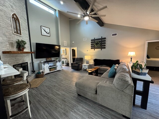 270 Lakeshore Dr, Brookeland, TX 75931 - living room featuring high vaulted ceiling, wood finished floors, a fireplace, ceiling fan, and beamed ceiling