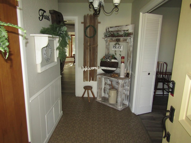 hallway with a notable chandelier