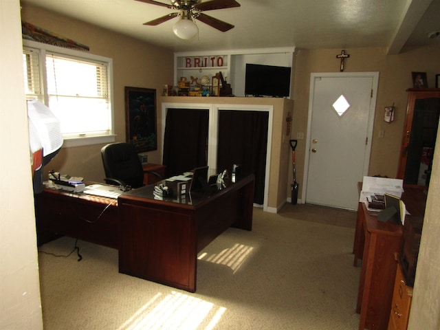 office space with ceiling fan and light colored carpet