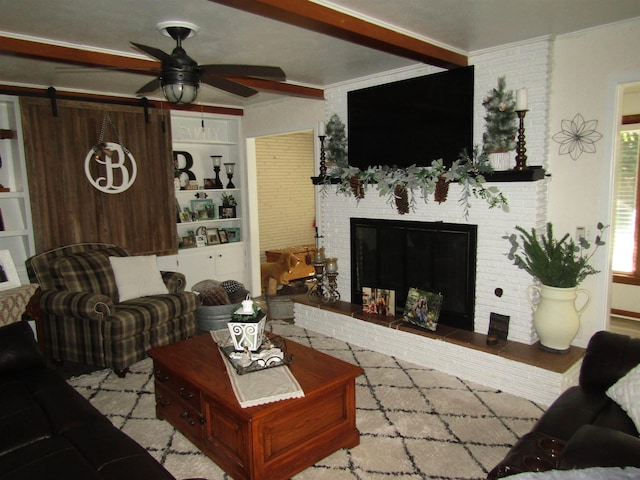 living room featuring ceiling fan, a barn door, ornamental molding, and brick wall