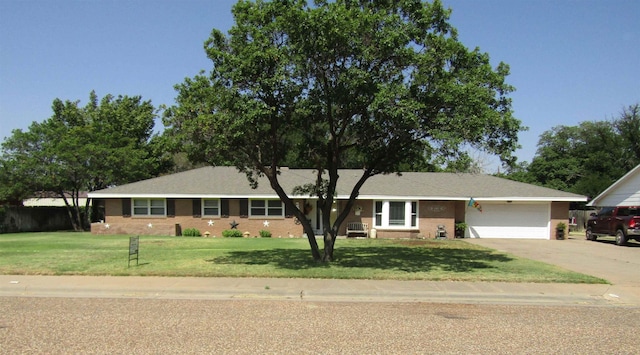 ranch-style home with a garage and a front lawn