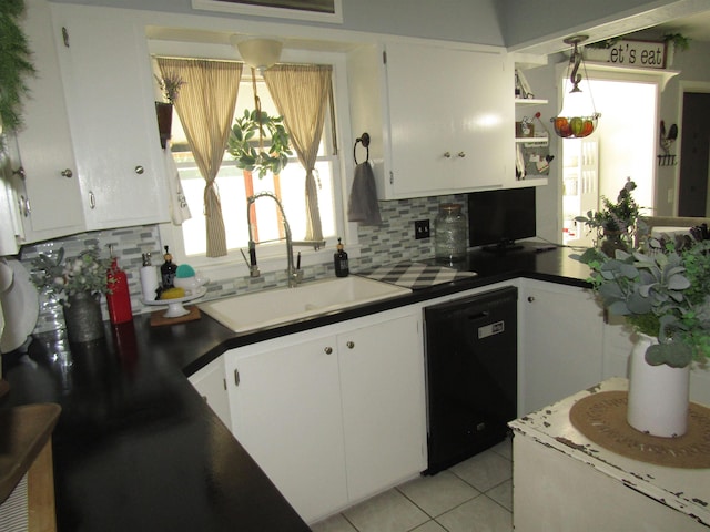 kitchen with tasteful backsplash, sink, dishwasher, white cabinetry, and light tile patterned flooring