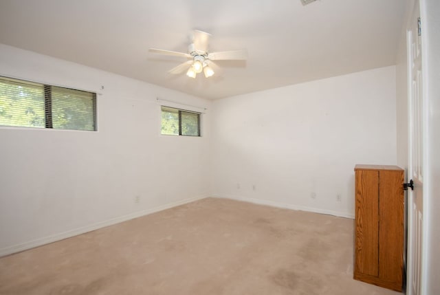 unfurnished room featuring ceiling fan and light colored carpet