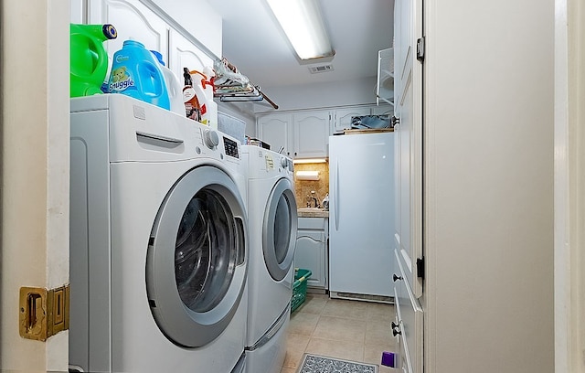 laundry room featuring sink, separate washer and dryer, and light tile patterned flooring