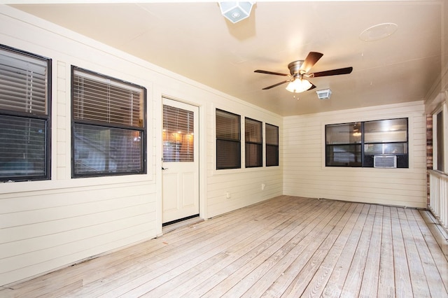 unfurnished sunroom featuring ceiling fan