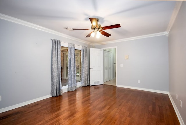 spare room featuring dark hardwood / wood-style flooring, ceiling fan, and crown molding