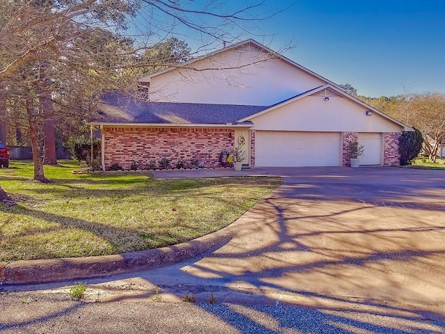 view of front of house featuring a garage and a front yard