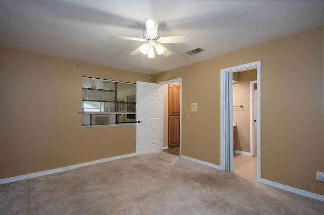 unfurnished bedroom with light carpet, ensuite bath, and ceiling fan