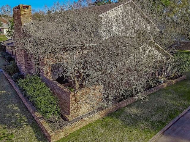 view of side of home with a lawn