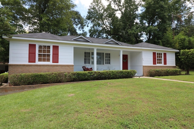 ranch-style home featuring a front yard and a porch