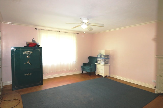 interior space featuring ceiling fan, dark hardwood / wood-style floors, and ornamental molding