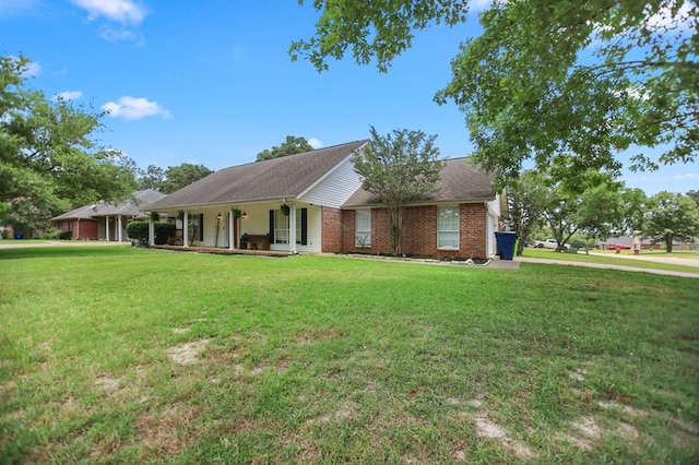 112 Lewellin Pl, Lufkin, TX 75904 - ranch-style house with a porch, a front lawn, and brick siding