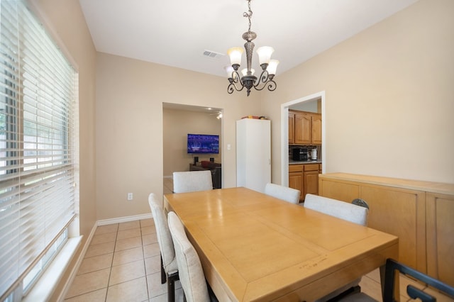 112 Lewellin Pl, Lufkin, TX 75904 - dining space featuring a chandelier, light tile patterned floors, and baseboards