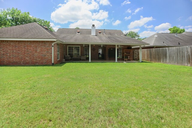 112 Lewellin Pl, Lufkin, TX 75904 - rear view of house featuring a chimney, a patio, roof with shingles, brick siding, and ceiling fan