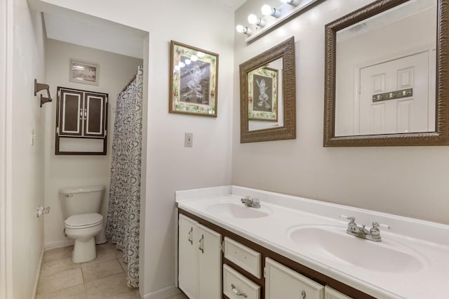 bathroom with tile patterned flooring, vanity, and toilet