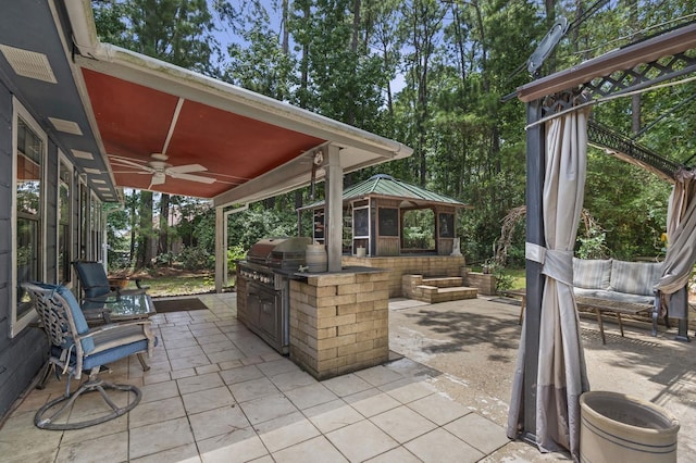 view of patio / terrace with a gazebo, ceiling fan, and area for grilling