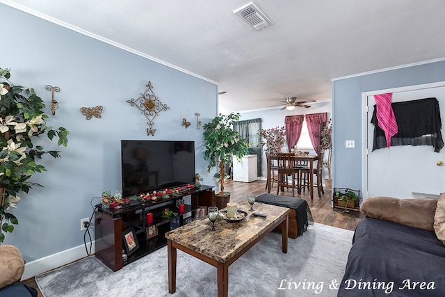 living room featuring hardwood / wood-style flooring, ceiling fan, and ornamental molding