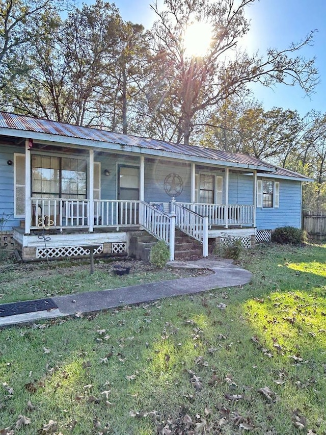 view of front of house with a front yard and a porch