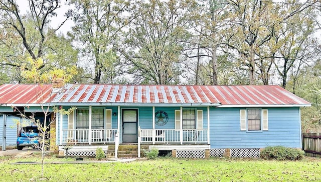 single story home featuring a carport, a porch, and a front yard