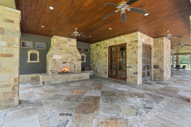 4207 S Chestnut St, Lufkin, TX 75901 - view of patio / terrace featuring ceiling fan, an outdoor stone fireplace, and french doors