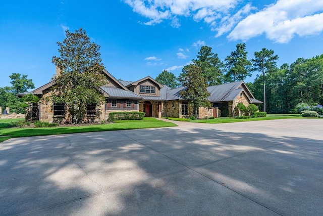 4207 S Chestnut St, Lufkin, TX 75901 - craftsman inspired home featuring a standing seam roof, stone siding, a front yard, and metal roof