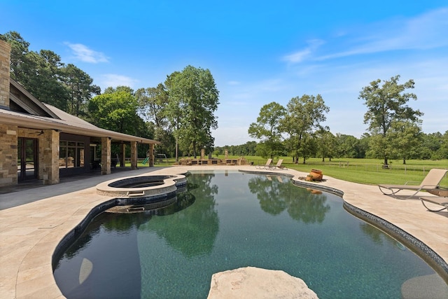 4207 S Chestnut St, Lufkin, TX 75901 - view of pool featuring a patio, a pool with connected hot tub, a yard, and view of scattered trees