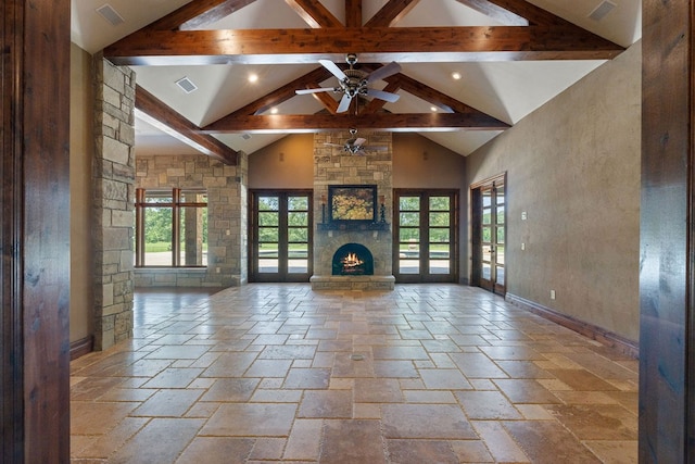 4207 S Chestnut St, Lufkin, TX 75901 - unfurnished living room with healthy amount of natural light, stone tile floors, beam ceiling, a fireplace, and high vaulted ceiling