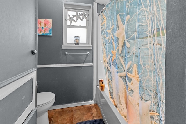 bathroom featuring tile patterned floors, toilet, and shower / bathtub combination with curtain