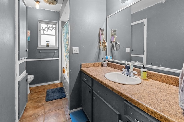 full bathroom with tile patterned floors, vanity, toilet, and shower / bath combo with shower curtain