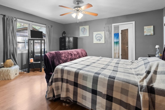 bedroom with hardwood / wood-style floors and ceiling fan