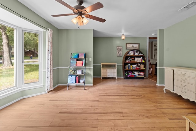 recreation room featuring ceiling fan and light hardwood / wood-style flooring