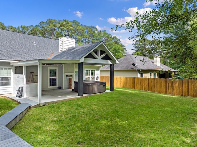 138 Breezeway Dr, Brookeland, TX 75931 - back of property with a lawn, a hot tub, fence, a patio area, and a shingled roof