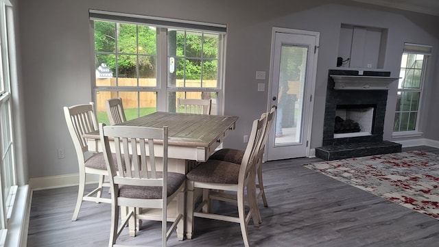 138 Breezeway Dr, Brookeland, TX 75931 - dining room with a fireplace with raised hearth, wood finished floors, and baseboards