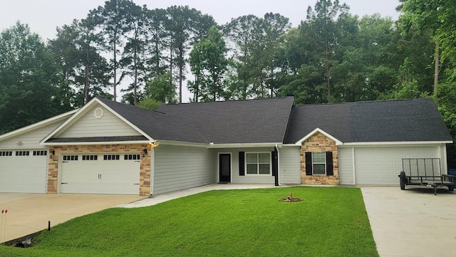 138 Breezeway Dr, Brookeland, TX 75931 - view of front of property featuring stone siding, a front yard, driveway, and a garage