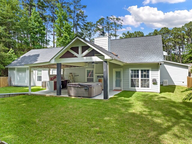 138 Breezeway Dr, Brookeland, TX 75931 - rear view of property featuring a hot tub, roof with shingles, a ceiling fan, and a patio